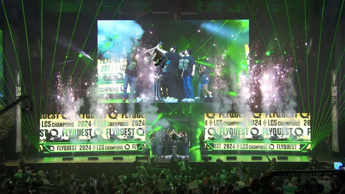 FlyQuest stand on stage lifting the LCS championship trophy after taking down Team Liquid.